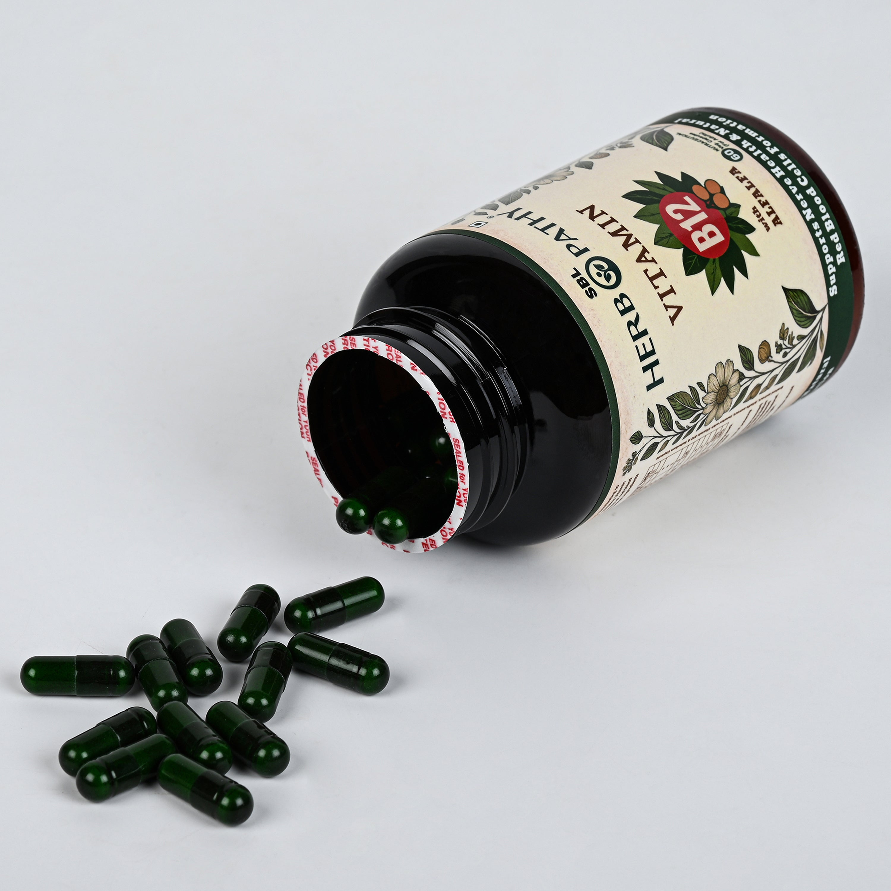 Vitamin B12 with Alfalfa capsules poured out showing green vegetarian capsules
